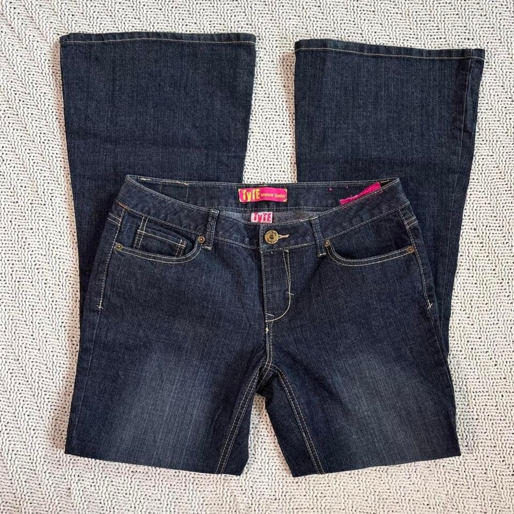 Insane 2000s low-rise bootcut denim with a dark wash and pink tag detail